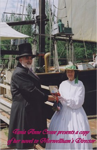 Tania Annne Crosse presents a copy of her novel to Morwellhams director