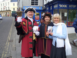 Outside the BookStop with Tavistock's Town Crier Bob Rose and his Lady Consort Shirley Rose.